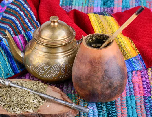 Cup from calabash and teapot with dry mate leaves.Traditional drink of Peru, Brazil and Argentina.