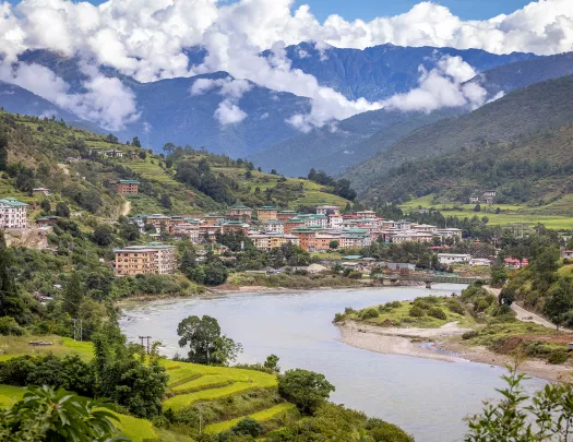 River next to  a town with tall, brown buildings